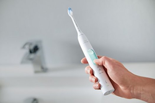 Sonicare ProtectiveClean 5100 in white version being held in bathroom